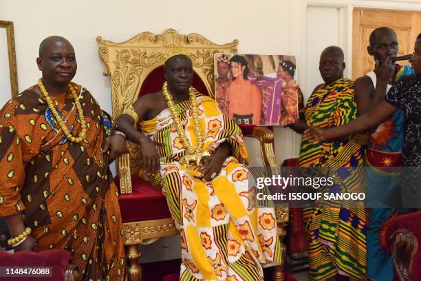 King Amon N'Douffou V, King of Krindjabo, capital of the Sanwi Kingdom, in the southeast of the Ivory Coast, poses with his his notables holding a...