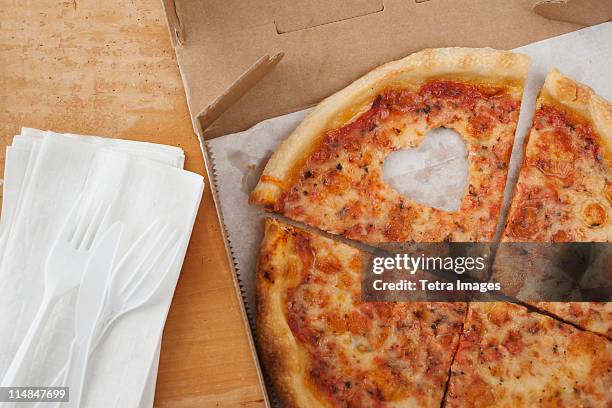 pizza with missing heart shaped piece - heart shape pizza stock pictures, royalty-free photos & images