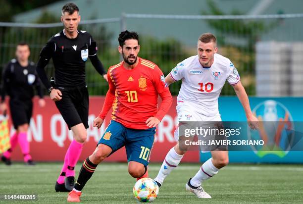 Faroe Islands' midfielder Solvi Vatnhamar challenges Spain's midfielder Isco during the UEFA Euro 2020 group F qualifying football match between...