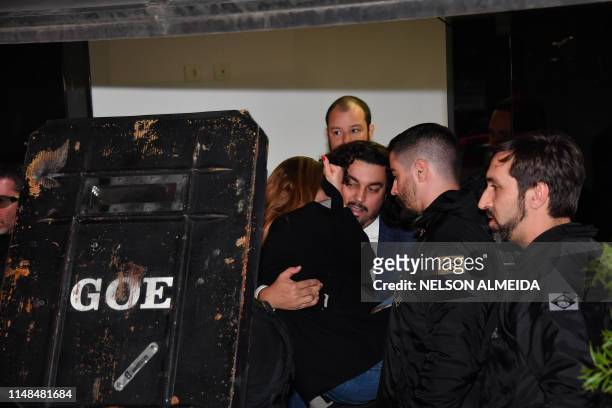 Najila Trindade Mendes de Souza is carried by her lawyer Danilo Garcia de Andrade as they leave the Women's Defence Precinct in Sao Paulo, Brazil, on...
