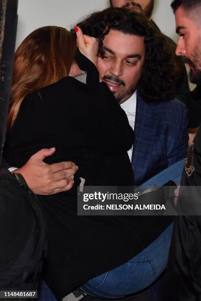 Najila Trindade Mendes de Souza is carried by her lawyer Danilo Garcia de Andrade as they leave the Women's Defence Precinct in Sao Paulo, Brazil, on...