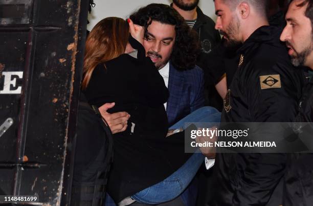 Najila Trindade Mendes de Souza is carried by her lawyer Danilo Garcia de Andrade as they leave the Women's Defence Precinct in Sao Paulo, Brazil, on...