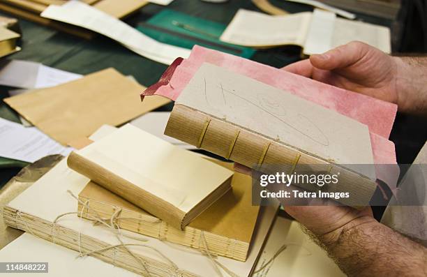 united kingdom, bristol, hands binding book - reliures photos et images de collection