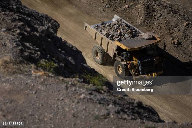 Dump truck moves raw ore inside the pit at the Mountain Pass mine, operated by MP Materials, in Mountain Pass, California, U.S., on Friday, June 7,...