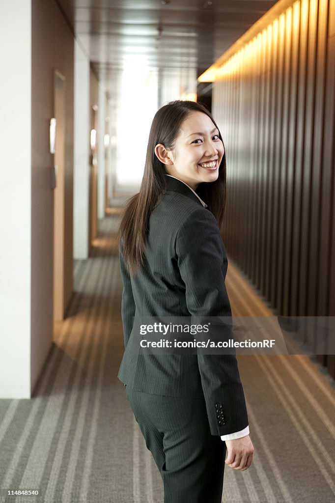 Young businesswoman turning, Tokyo Prefecture, Honshu, Japan