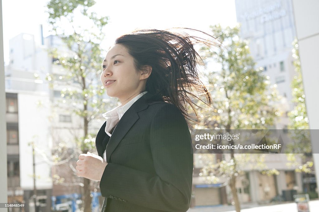 Businesswoman running, Tokyo Prefecture, Honshu, Japan