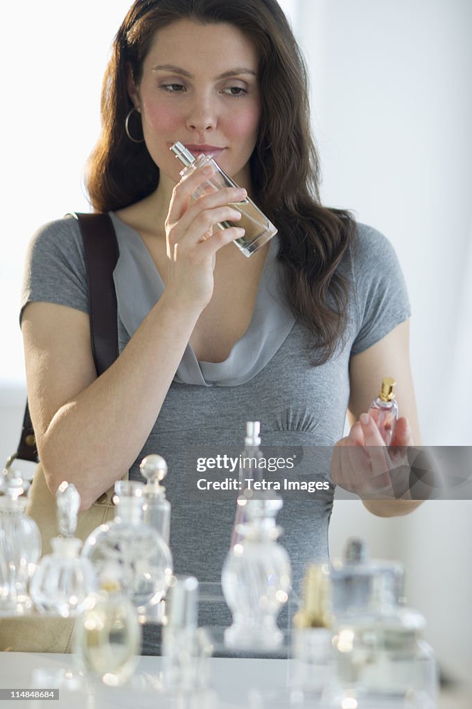 USA, New Jersey, Jersey City, Young woman testing perfume