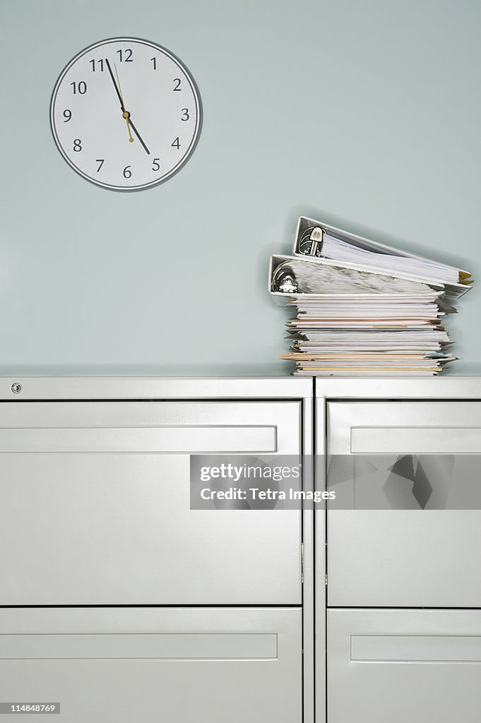 USA, New Jersey, Jersey City, Stack of documents on filing cabinet