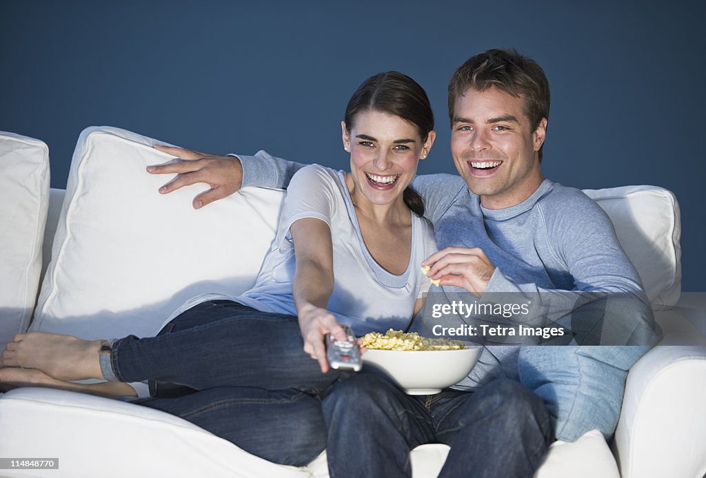 Couple sitting in front of television
