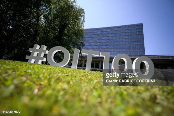 Sign commemorating the 100th anniversary of the International Labour Organization is pictured in front of its headquarters on June 7, 2019 in Geneva....