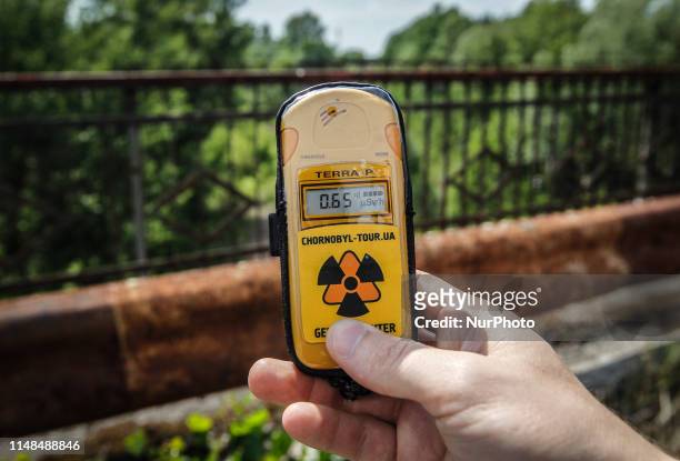 Visitor measures the level of radiation on the so-called Death bridge in the abandoned city of Pripyat, near the Chernobyl nuclear power plant,...