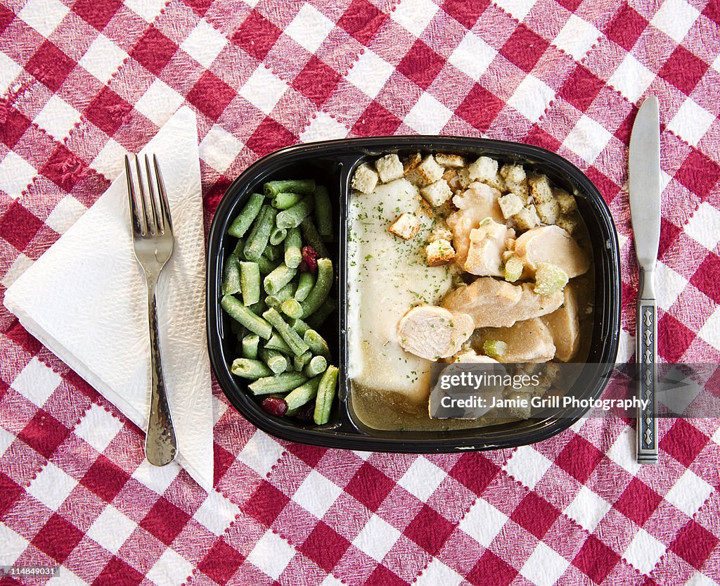 USA, New Jersey, Jersey City, close up of TV dinner on checked table cloth
