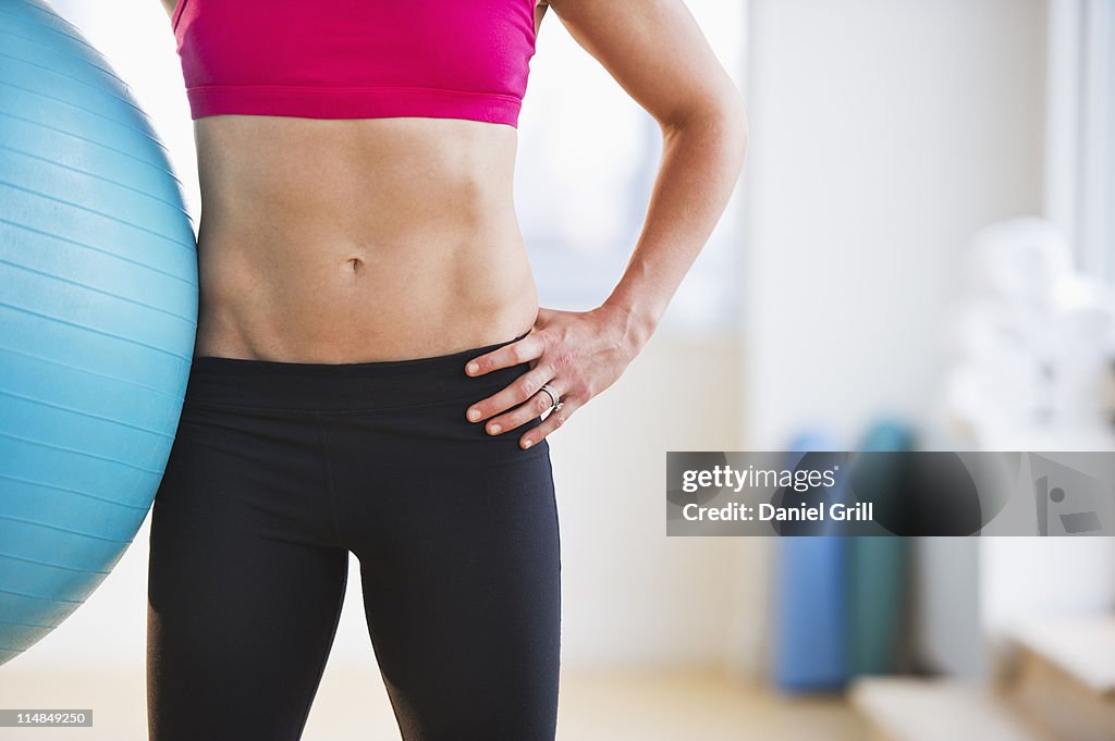 USA, New Jersey, Jersey City, midsection of woman holding fitness ball