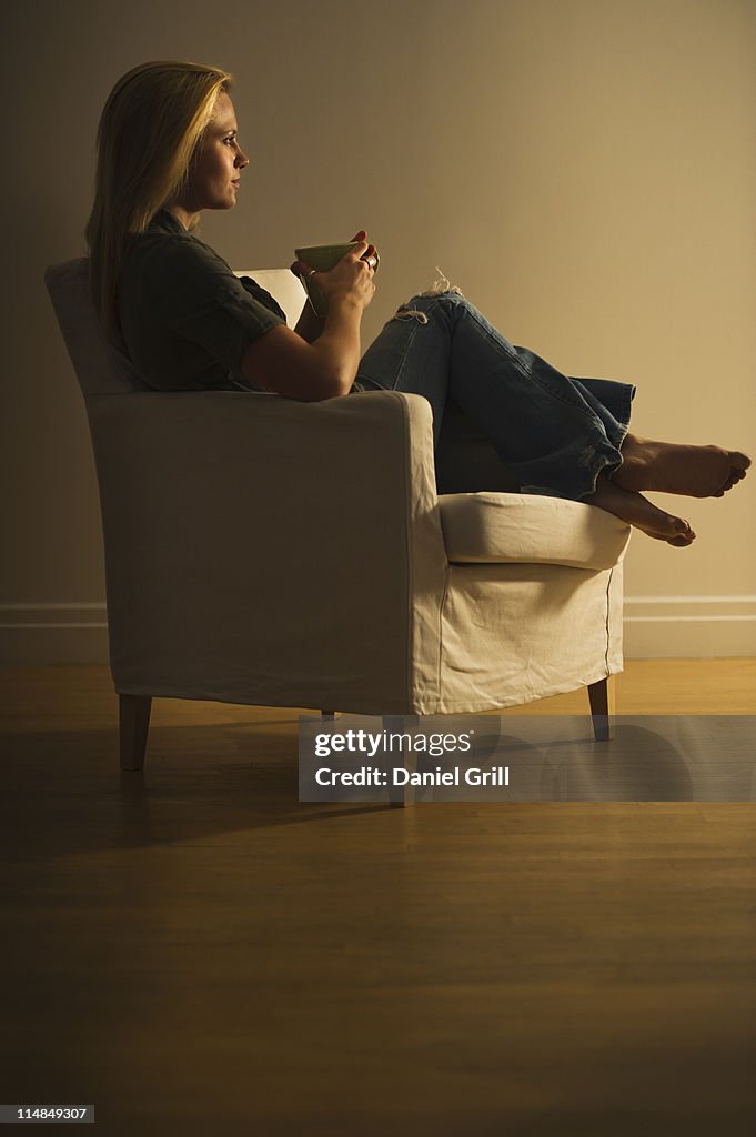 Woman sitting in armchair