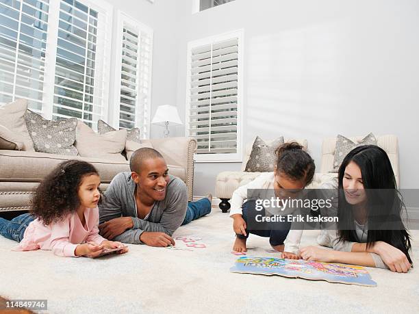 family relaxing on living room floor - mom flirting stock pictures, royalty-free photos & images