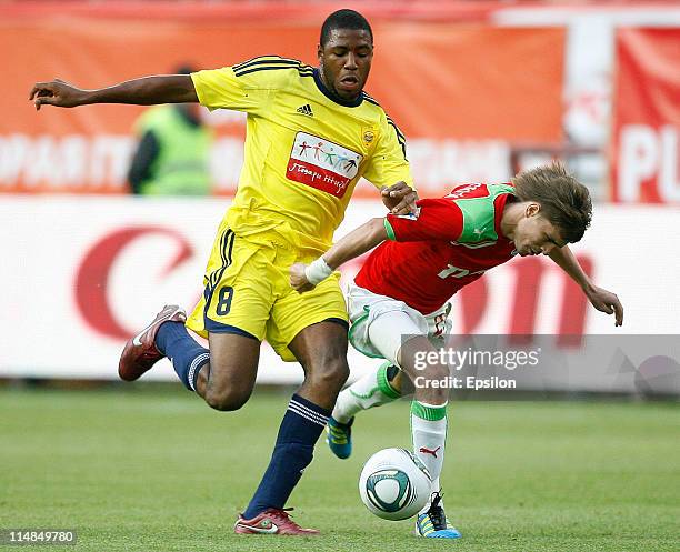 Dmitry Torbinsky of FC Lokomotiv Moscow battles for the ball with Jusiley of FC Anzhi Makhachkala during the Russian Football League Championship...