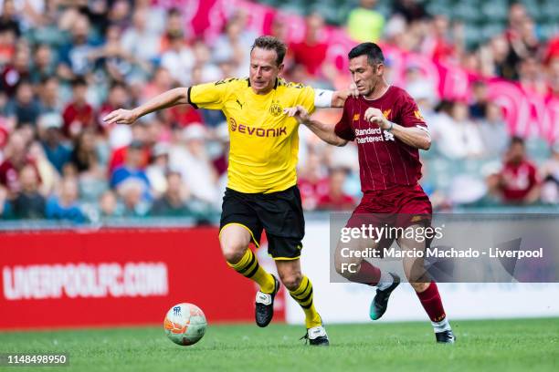 Luis Garcia of Liverpool FC fights for the ball with Jorg Heinrich of Borussia Dortmund during the match between Liverpool Legend and Borussia...