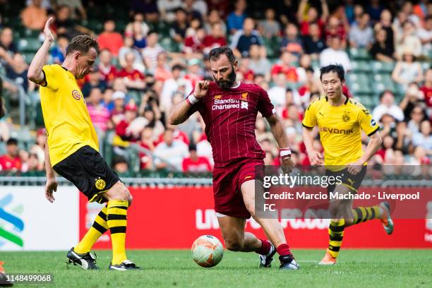 Jason McAteer of Liverpool FC fights for the ball with Jorg Heinrich of Borussia Dortmund during the match between Liverpool Legend and Borussia...