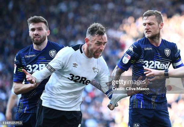 Richard Keogh of Derby County reacts with Liam Cooper and Stuart Dallas of Leeds United during the Sky Bet Championship Play-Off Semi Final First Leg...