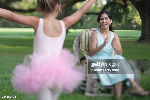 elegant mother sitting in backyard with ballerina daughter - family with one child mother bonding family adult daughter focus on background leisure stock-fotos und bilder