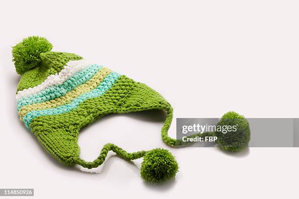 green and white wooly hat - white pom pom stock pictures, royalty-free photos & images