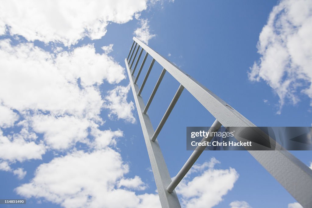 USA, New Jersey, ladder reaching cloudy sky