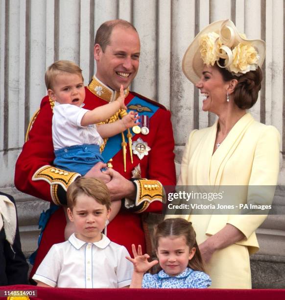 The Duke and Duchess of Cambridge with their children, Prince Louis, Prince George and Princess Charlotte, on the balcony of Buckingham Place as they...