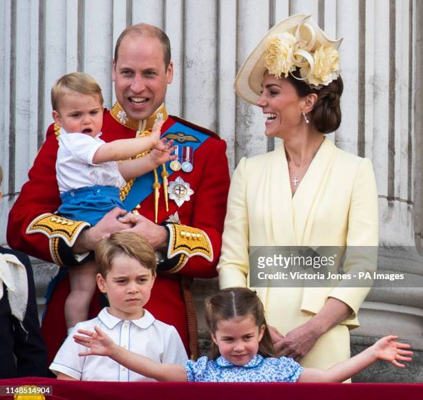The Duke and Duchess of Cambridge with their children, Prince Louis, Prince George and Princess Charlotte, on the balcony of Buckingham Place as they...