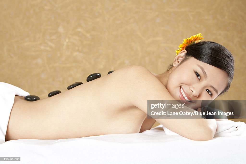 Young woman having stone therapy