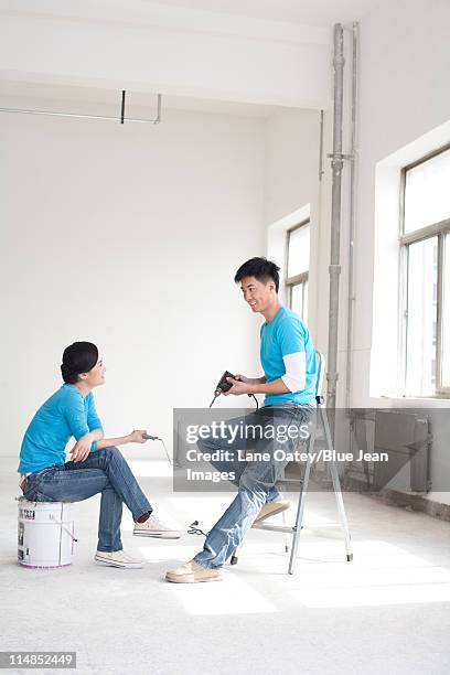 couple taking a break from remodeling - asian ceiling stock pictures, royalty-free photos & images