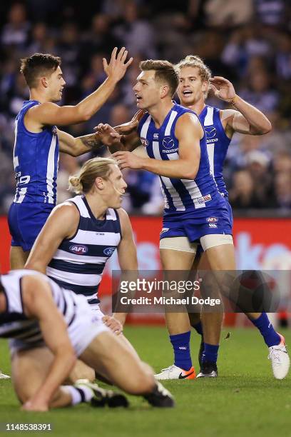 Shaun Higgins of the Kangaroos celebrates a goal with teammates during the round eight AFL match between the North Melbourne Kangaroos and the...