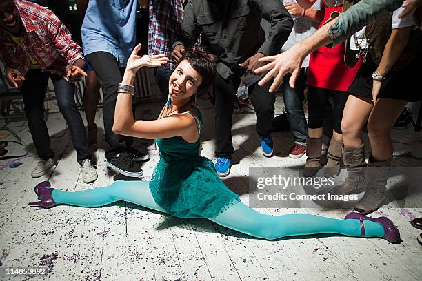 woman wearing green dress at party doing the splits - know it all stock pictures, royalty-free photos & images