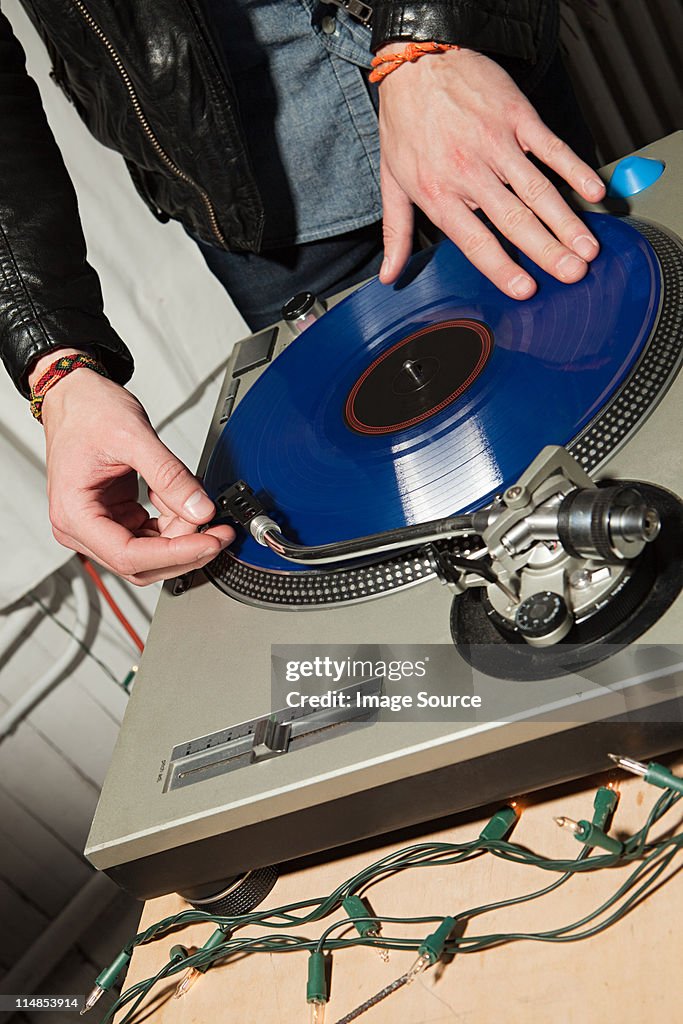 Disc jockey at party on mixing desk