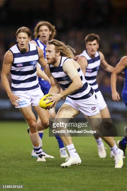 Cameron Guthrie of the Cats runs with the ball during the round eight AFL match between the North Melbourne Kangaroos and the Geelong Cats at Marvel...