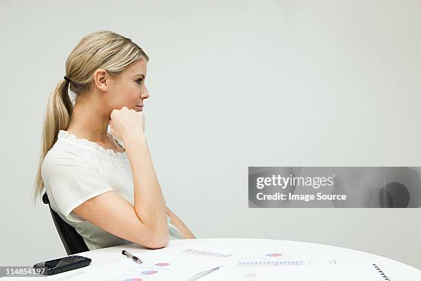 portrait of businesswoman at table - leaning on elbows stock pictures, royalty-free photos & images