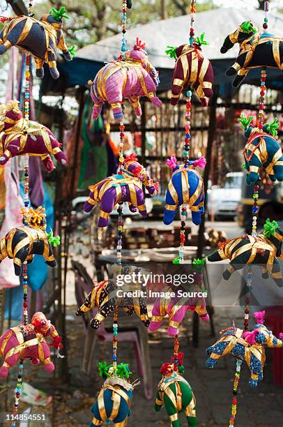 colourful silk elephant mobiles for sale in market stall, cochin, kerala - cochin stockfoto's en -beelden