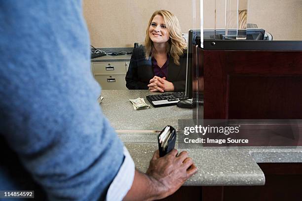 bank teller working in bank - bank counters stock pictures, royalty-free photos & images