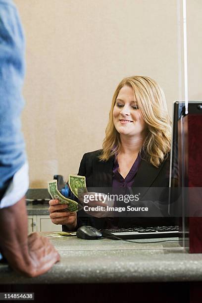 bank teller working in bank - bank teller and customer stock pictures, royalty-free photos & images