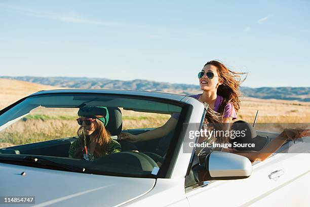 três mulheres condução em conversível carro - convertible imagens e fotografias de stock