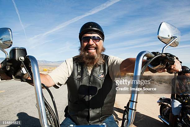 portrait of senior motorcyclist - waistcoat stock-fotos und bilder