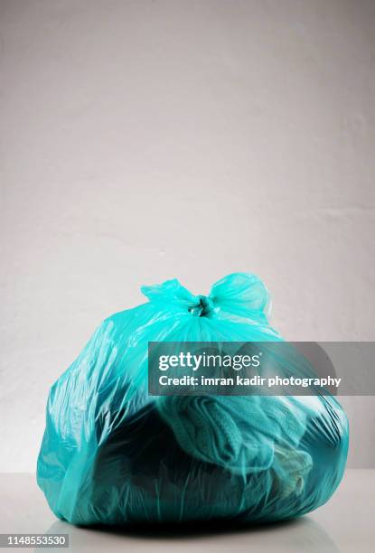 photo for cloth in plastic bag - clothes waste bildbanksfoton och bilder