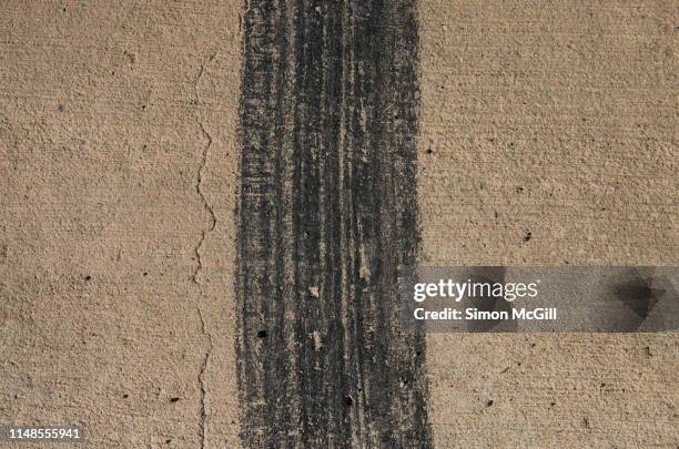 skidmark on a concrete driveway - skid marks stock pictures, royalty-free photos & images