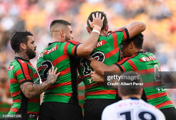 Sam Burgess of the Rabbitohs celebrates with team mates after scoring a try during the round nine NRL match between the South Sydney Rabbitohs and...