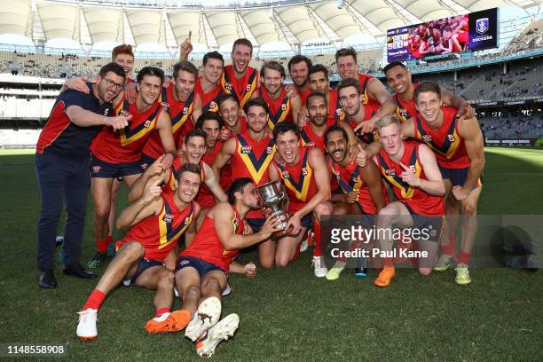 The SANFL team pose with the Haydn Bunton Jnr Cup after winning the state game between WA and SA at Optus Stadium on May 12, 2019 in Perth, Australia.