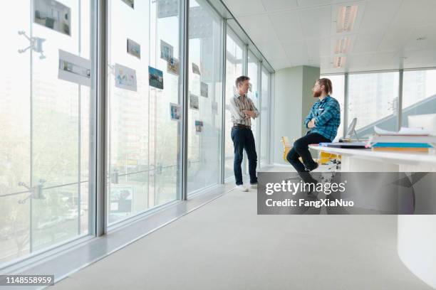 men talking in design office meeting room - classroom wide angle stock pictures, royalty-free photos & images