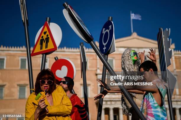 People take part in the Athens Gay Pride in front of Parliament House in Athens on June 8, 2019. - Thousands marched in the 15th annual Athens Pride...
