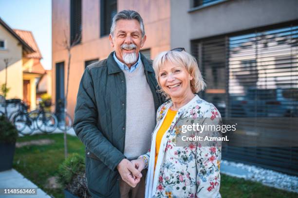 relaxed senior couple outside vacation residence - grey hair stock pictures, royalty-free photos & images