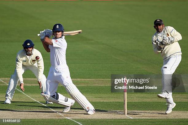 Alastair Cook of England hits to the offside as wicketkeeper Prasanna Jayawardene and Rangana Herath look on during day two of the 1st npower test...