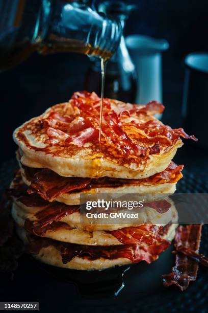 stack of pancakes with crispy bacon and maple syrup - maple syrup pancakes stock pictures, royalty-free photos & images