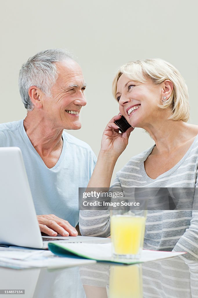 Mature couple using laptop